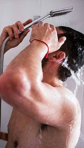 Man drying off with a plush, eco-friendly ORNAMAJO towel after showering, showcasing superior absorbency and softness.